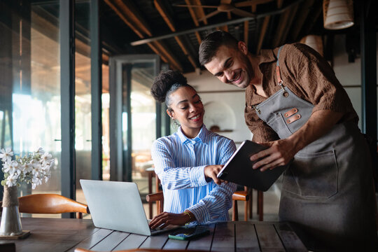 Chef and manager teamwork. Successful meeting with tablet in restaurant for effective collaboration