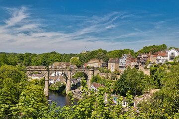 Fototapeta premium River View with Stone Viaduct and Residential Buildings in Knaresborough, UK.