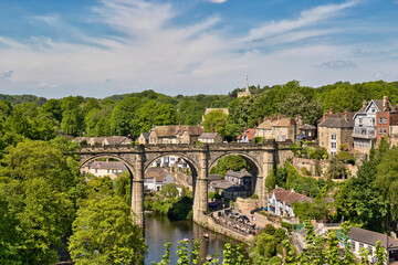 Stone Viaduct Over River with Buildings and Landscape  in Knaresborough, UK.