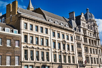 Ornate stone buildings with varied window designs and dormers  in London, UK.
