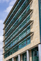 Modern Building Facade with Stone and Glass Windows  in Newcastle upon Tyne, UK.