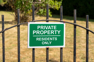 Private property sign on iron gate outdoors