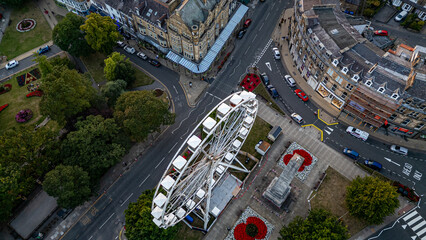 Aerial view of town square with Ferris wheel and surrounding elements  in Harrogate, UK.