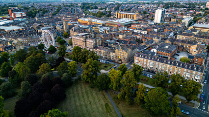Aerial View of City Center with Ferris Wheel, Buildings, and Park  in Harrogate, UK.