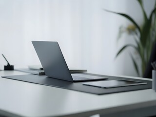 Modern minimalist workspace with a sleek laptop and tablet on a clean white desk, promoting a focused and productive work environment