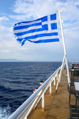 The Greek national flag on a passenger ferry. Aegean Sea, Greece