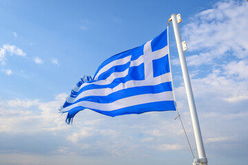 The Greek national flag under blue sky. Greece
