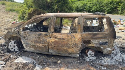 Burned Minivan on Dirt Road