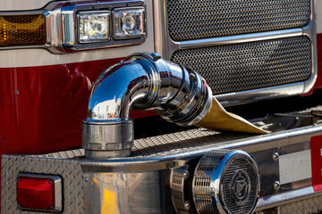 Bumper of a fire truck with an auxiliary hose hookup
