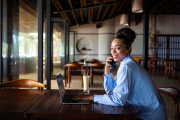 Remote work, communication. African american business woman on a phone call with a laptop working