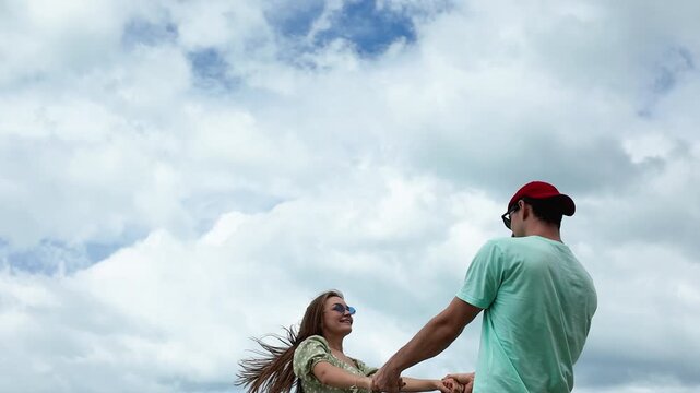 Happy caucasian couple having fun at the beach together. smiling beautiful young couple pending time together at the beach