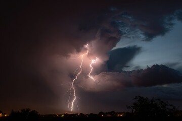 Dramatic display of lightning illuminates sky, surrounded by dark storm clouds. scene captures raw power of nature, evoking sense of awe and wonder