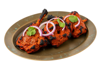 Grilled lamb skewers, richly spiced and garnished with sliced red onions and fresh cilantro, displayed on an ornate dark-bronze platter against a black background.