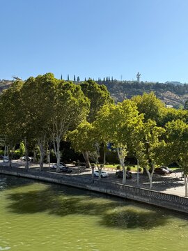 Distant view across the Kura river of the Kartlis Deda (Mother of Georgia) sculpture on Sololaki Hill, Tbilisi, Georgia