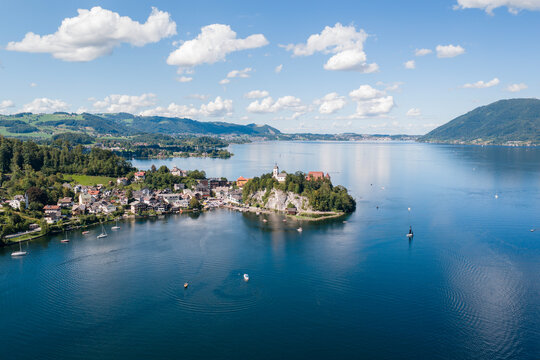 Aerial view of Boats sailing past Traunkirchen on a peninsula in Lake Traunsee, Salzkammergut, Upper Austria, Austria