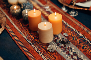 Beautiful ethnic patterned table runner with candles for a cozy evening setting