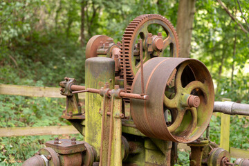 Old rusted machinery in wooded area