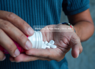 Close-up of a man pouring white pills into hand with digital medication reminder overlay. Daily medicine routine, healthcare technology and self-care concept.