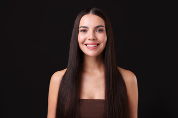 Naklejka premium Woman with beautiful smooth hair after lamination procedure on black background