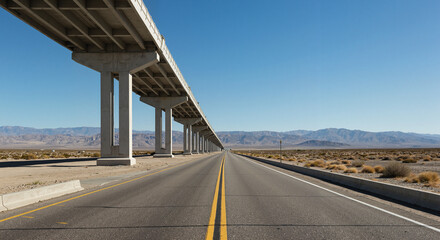 Naklejka premium Road beneath elevated highway surrounded by desert landscape 