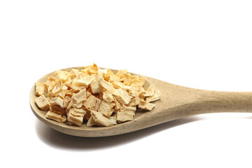 Slices, chopped of dried celery root in wooden spoon isolated on white background, side view