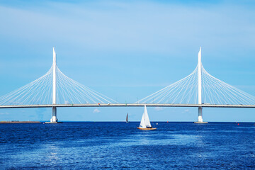 A lonely sailboat near the cable-stayed automobile bridge across the Gulf of Finland.