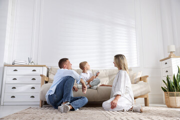 Family using remote to control air conditioner at home