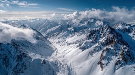 Majestic Aerial View of Snow-Capped Mountain Peaks in Clear Sky