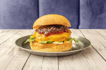 Explosion of flavors in one burger: brioche bun, beef, fried egg, avocado, and homemade mayonnaise, in a casual setting