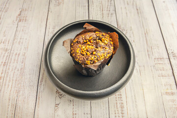 Cinnamon raisin oatmeal muffins, served warm on fine English bone china with a wildflower design and gold trim
