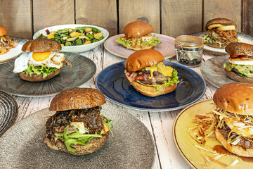 Gourmet burger with buttered toasted brioche bun, a thick grilled beef patty, and fresh red onion rings.