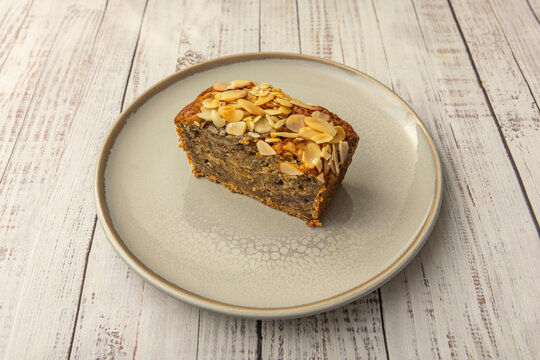 Carrot sponge cake with walnut pieces and raisins, sprinkled with cinnamon and topped with a smooth cream cheese frosting and rustic decoration - Powered by Adobe