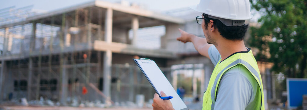 Construction site manager worker with safety helmet check building construction site.