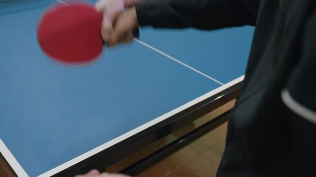 Close up during coaching session showing focused moment at tennis table as player receives training and guidance to improve technique and performance through practice