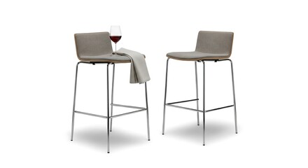 Fototapeta premium A pair of modern grey upholstered bar stools with sleek chrome metal legs, one with a glass of red wine and a napkin, isolated on a white background.