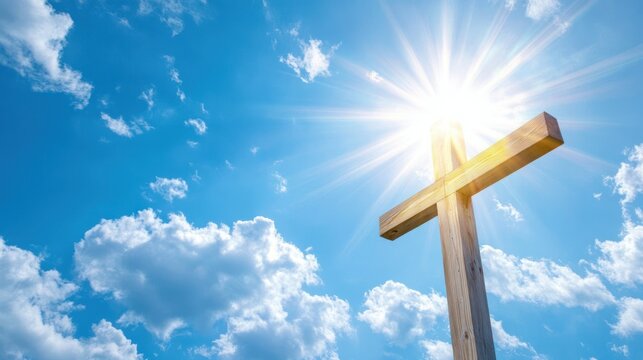 Wooden cross with sun rays and blue sky