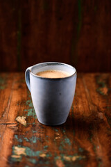 Cup of coffee on rustic wooden background. Soft focus. Copy space	