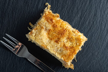 Moist layered apple semolina pie with crispy golden topping - top view.