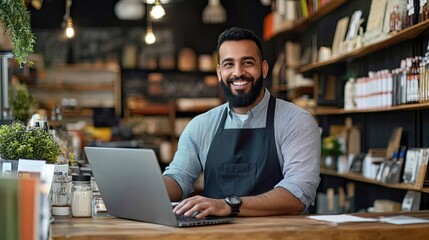 Fototapeta premium Small business owner using laptop in store