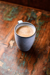 Cup of coffee on rustic wooden background. Soft focus. Copy space	