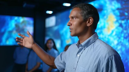 Environmental science educator teaching climate modeling through immersive data visualization with students examining weather patterns and ecosystem changes using augmented - Powered by Adobe