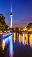 Obraz premium Nighttime cityscape by a river