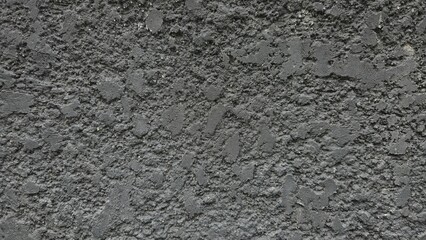 Rough black cement wall with stains and cracks. Fence texture. Background texture image.