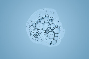 A beautiful drop of cosmetic product with bubbles on a blue background.