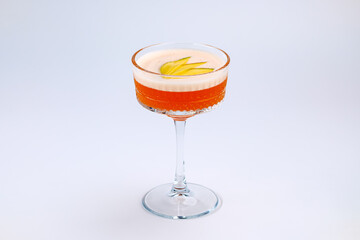 A sophisticated cocktail presented in a clear stemmed glass with garnished fresh fruit. The scene exudes elegance and refinement, perfect for luxury dining, celebrations, or social gatherings.