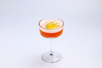 A sophisticated cocktail presented in a clear stemmed glass with garnished fresh fruit. The scene exudes elegance and refinement, perfect for luxury dining, celebrations, or social gatherings.