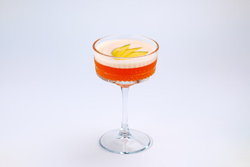 A sophisticated cocktail presented in a clear stemmed glass with garnished fresh fruit. The scene exudes elegance and refinement, perfect for luxury dining, celebrations, or social gatherings.