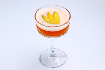 A sophisticated cocktail presented in a clear stemmed glass with garnished fresh fruit. The scene exudes elegance and refinement, perfect for luxury dining, celebrations, or social gatherings.