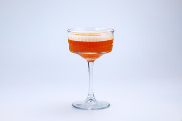 A sophisticated cocktail presented in a clear stemmed glass with garnished fresh fruit. The scene exudes elegance and refinement, perfect for luxury dining, celebrations, or social gatherings.