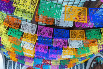 A colorful display of paper lanterns hangs from the ceiling. The lanterns are of various colors and...